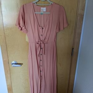 Gorgeous peach button up midi dress with midriff cutout.